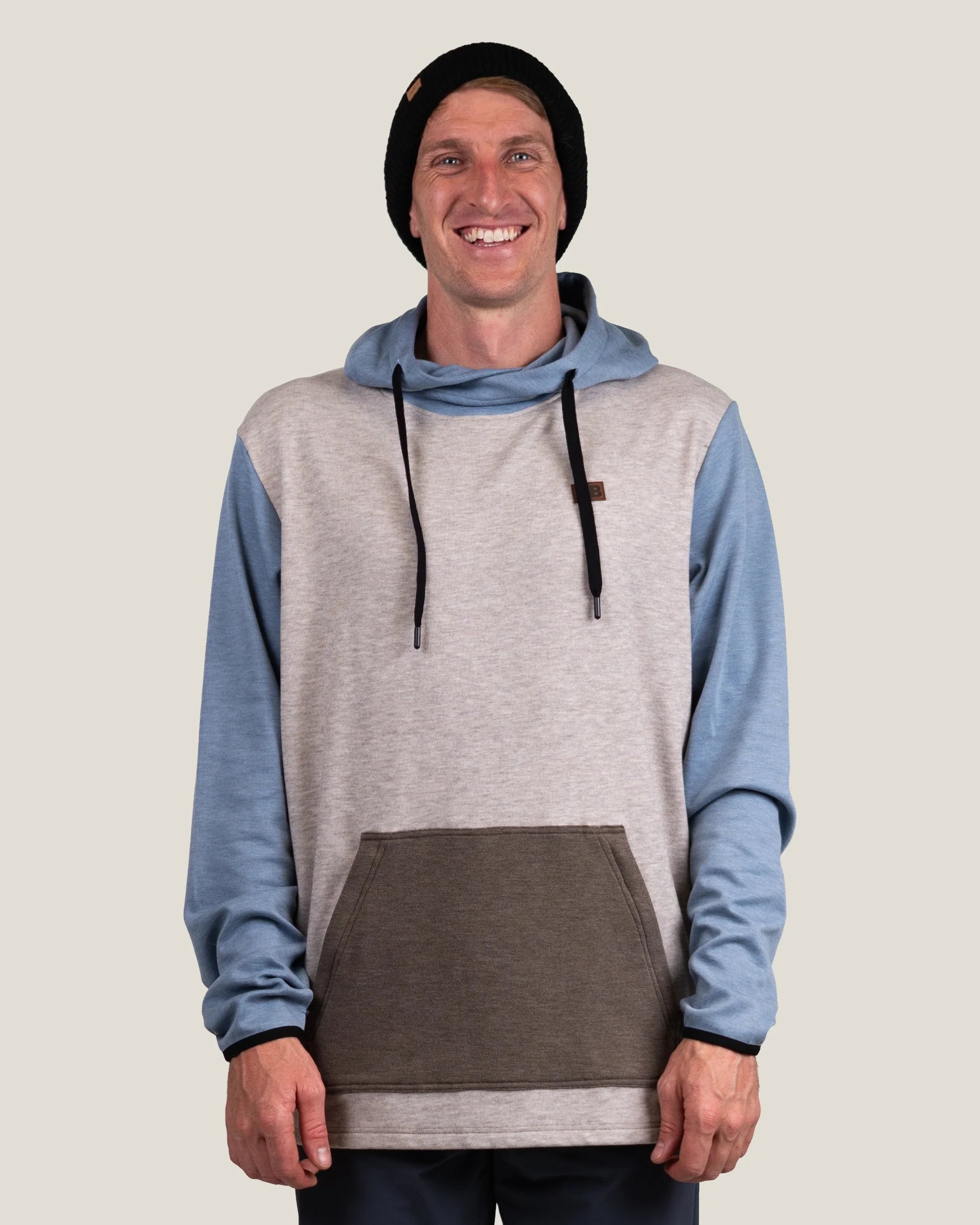 Men's colorblock pullover hoodie with blue sleeves, beige body, and brown front pocket, front view