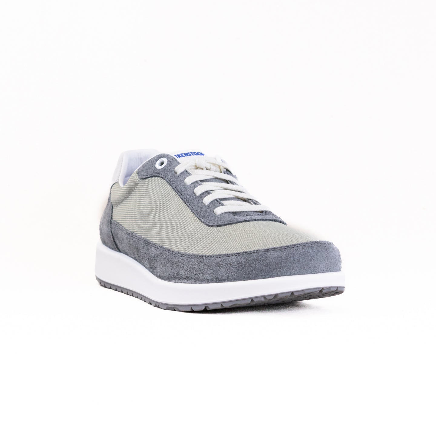 Gray and beige casual sneaker with white laces and sole, side profile view