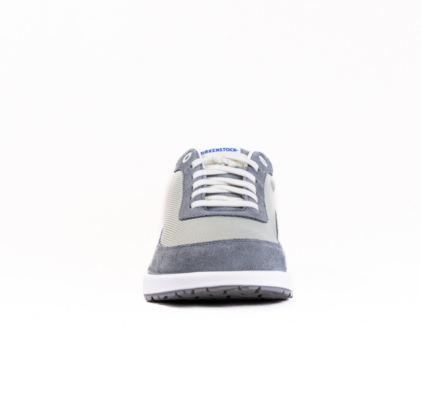 Gray and beige lace-up sneaker with textured panels, front toe view on white background