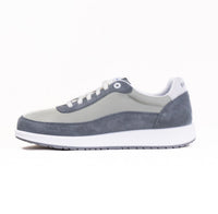 Gray and beige low-top sneaker with white laces and sole, side profile view