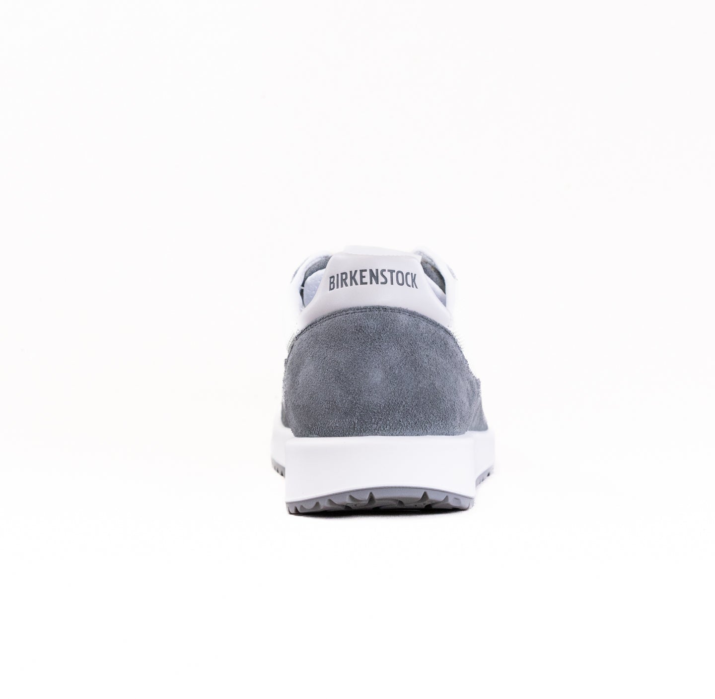 Gray suede sneaker with white sole and heel counter, rear view