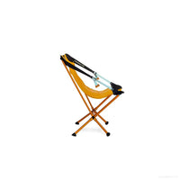 Orange portable camping chair with X-frame legs and fabric seat on white background