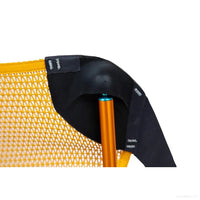Orange camping chair detail showing curved black frame support and mesh fabric