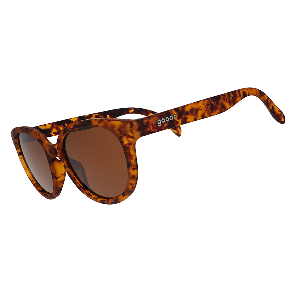 Round oversized tortoiseshell sunglasses with brown lenses, angled three-quarter view