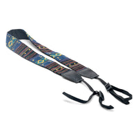 Woven tapestry camera strap with colorful geometric pattern and black leather ends and buckle clips