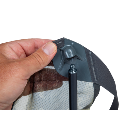 Hand adjusting gray camping chair headrest showing ergonomic design and fabric details