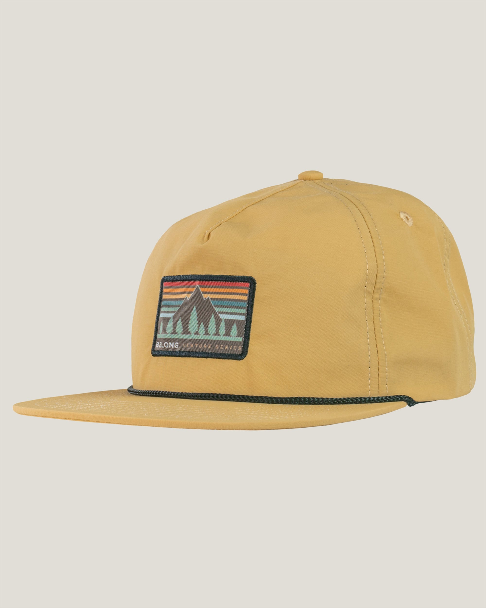 Golden yellow flat-brim snapback hat with embroidered mountain landscape patch, side angle view