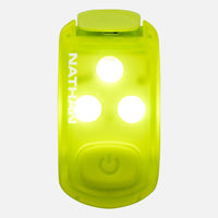 Bright green LED safety light clip with three illuminated white lights and power button