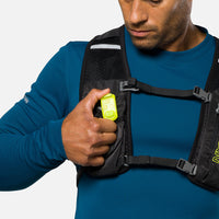 Bright yellow LED safety light clipped to chest strap of running vest