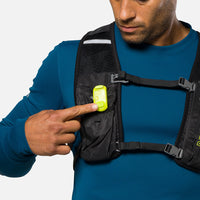 Bright LED safety light clipped to black chest pack worn by person in blue shirt