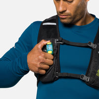 LED safety light clipped to black chest harness worn over blue athletic shirt
