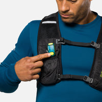 LED safety light clipped to chest pocket of running vest worn by person