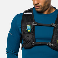 LED safety light clipped to chest harness pocket on runner wearing blue athletic shirt