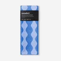 Packaged blue patterned towel with wavy design in product packaging