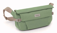 Sage green canvas hip bag with roll-top flap, beige adjustable crossbody strap, front view