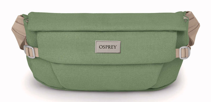 Green hip bag with roll-top flap, beige adjustable strap, and logo patch, front view