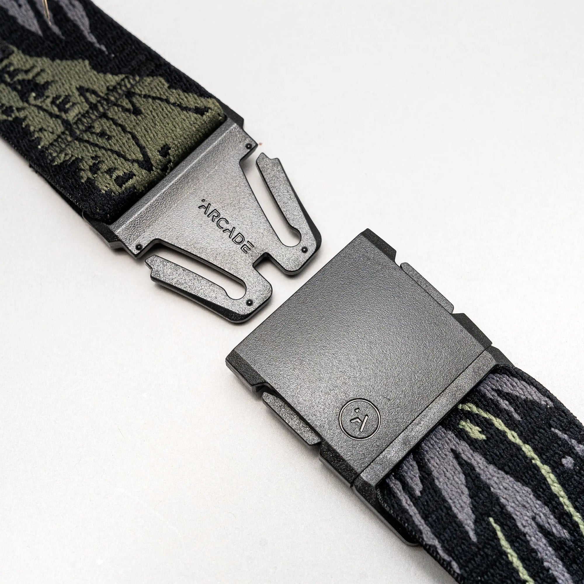 Tactical belt with camouflage webbing and gray quick-release buckle shown partially unbuckled