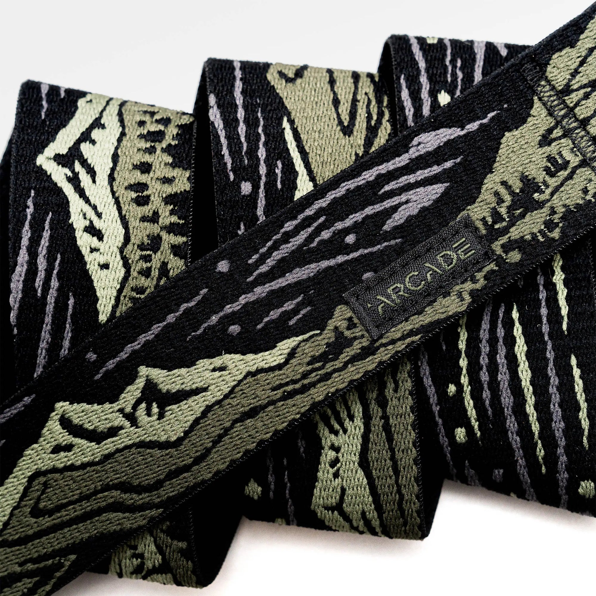 Patterned adventure belt with geometric design in dark green, black and white colors