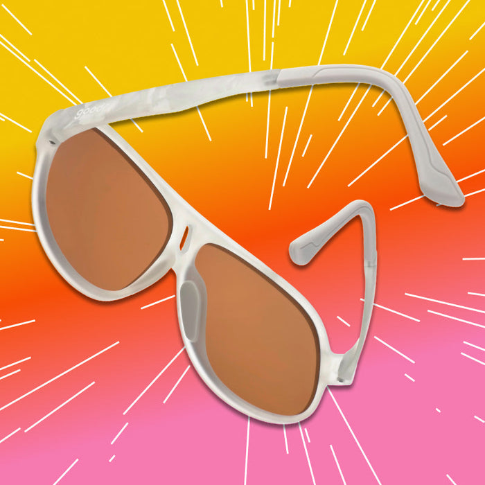 Aviator-style sunglasses with white marble frame and amber lenses, angled product view