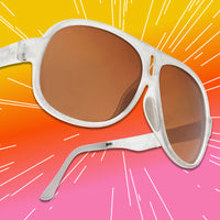 Oversized aviator sunglasses with clear white frame and amber brown lenses, angled view