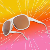 Oversized aviator sunglasses with white marble frame and amber lenses, three-quarter angle view