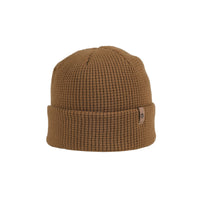 Waffle-knit cuffed beanie in warm tan with small leather logo patch, front view