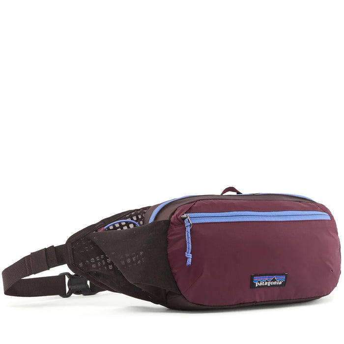 Hip pack fanny bag in dark plum with light blue zipper, mesh side panel, and adjustable strap