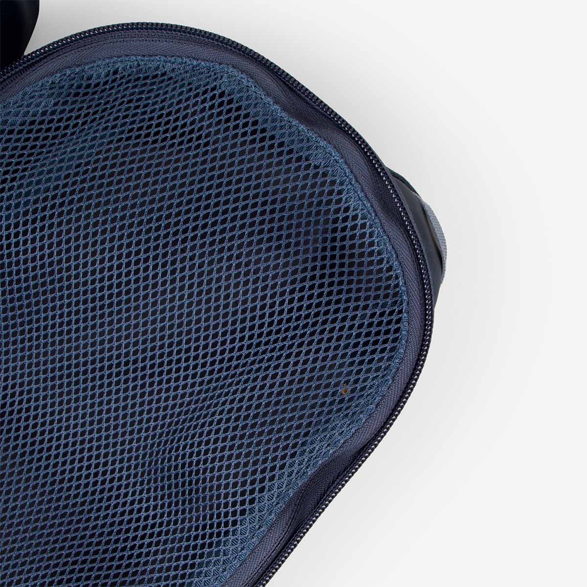 Close-up detail of navy blue mesh fabric cube bag with zipper closure, top view