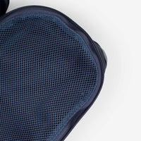 Close-up detail of navy blue mesh fabric cube bag with zipper closure, top view