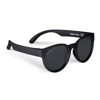 Round frame kids sunglasses in matte black with dark lenses, angled side view