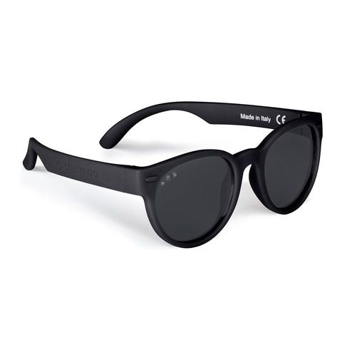Round frame kids sunglasses in matte black with dark lenses, angled side view