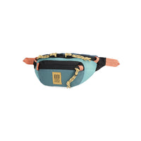 Teal waist pack with coral straps and navy accents, shown from quarter angle view