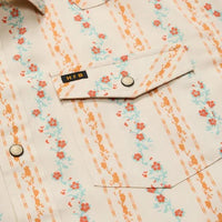 Close-up detail of floral striped snap-button shirt showing chest pocket and snap closure