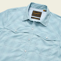 Light blue checkered button-up shirt with snap buttons and chest pockets, angled front view