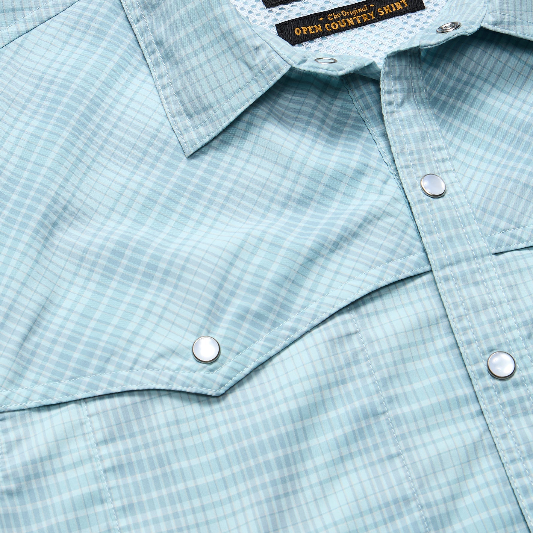 Light blue gingham plaid shirt with snap buttons and pointed collar, close-up detail view
