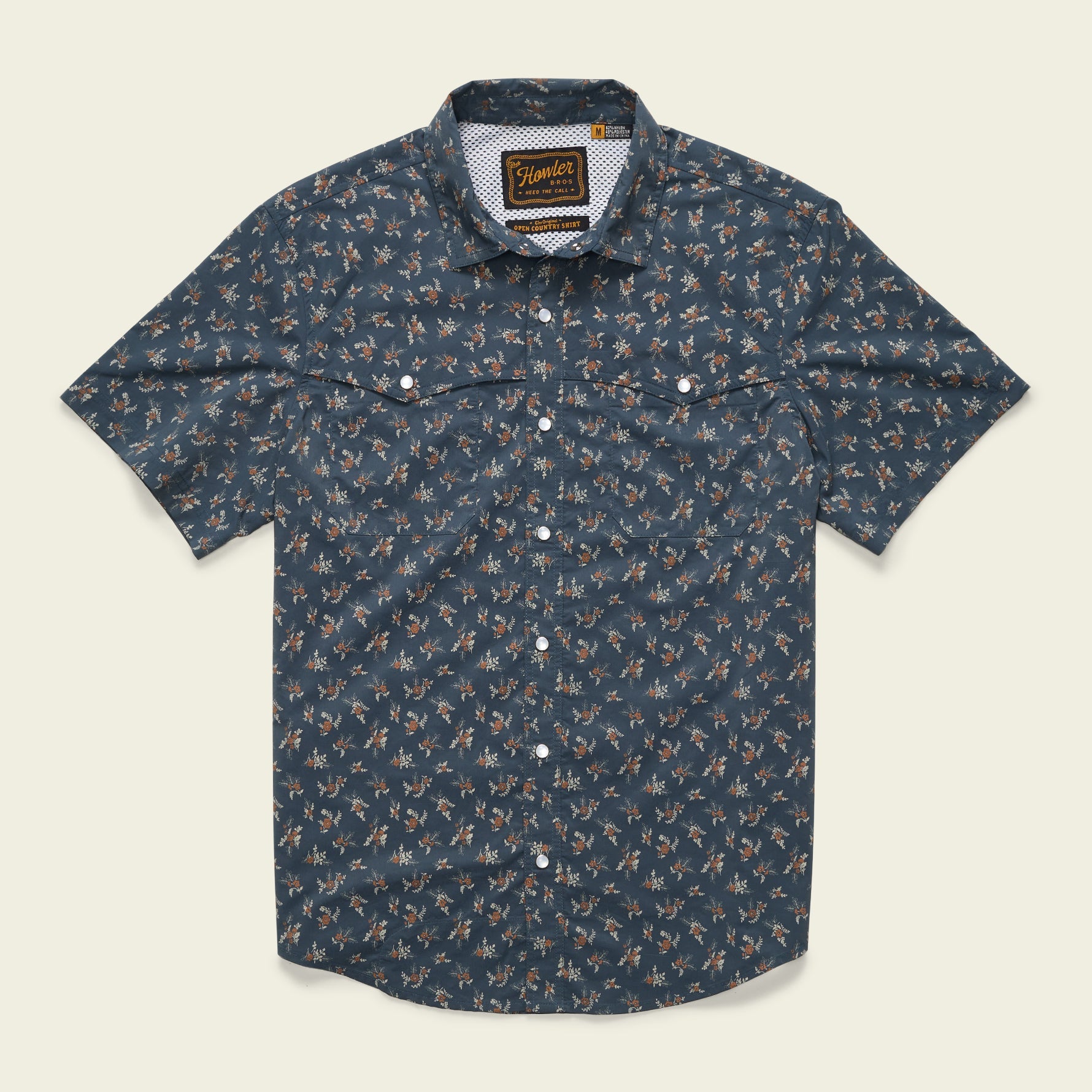 Short sleeve button-up shirt with small floral print on dark blue background, flat front view