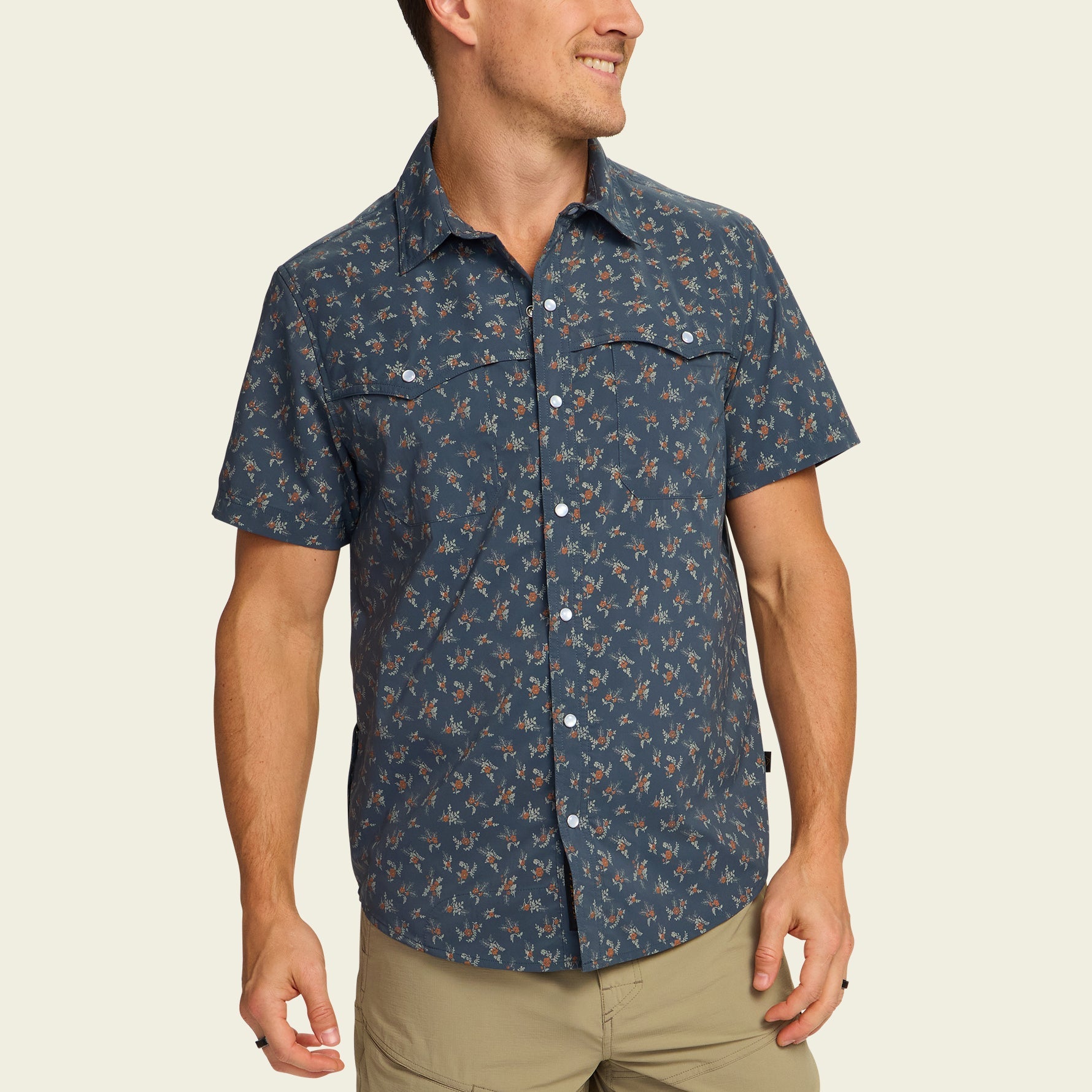 Dark blue short-sleeve button-up shirt with small floral print, worn by male model
