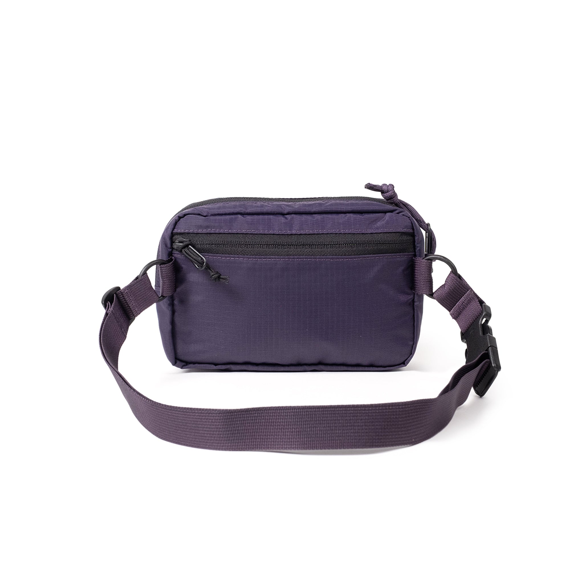 Purple crossbody bag with adjustable strap and front zip pocket on white background