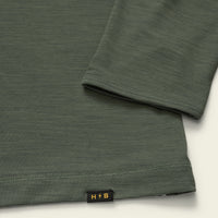 Olive green long sleeve hoodie detail showing sleeve cuff and hem with small logo tag
