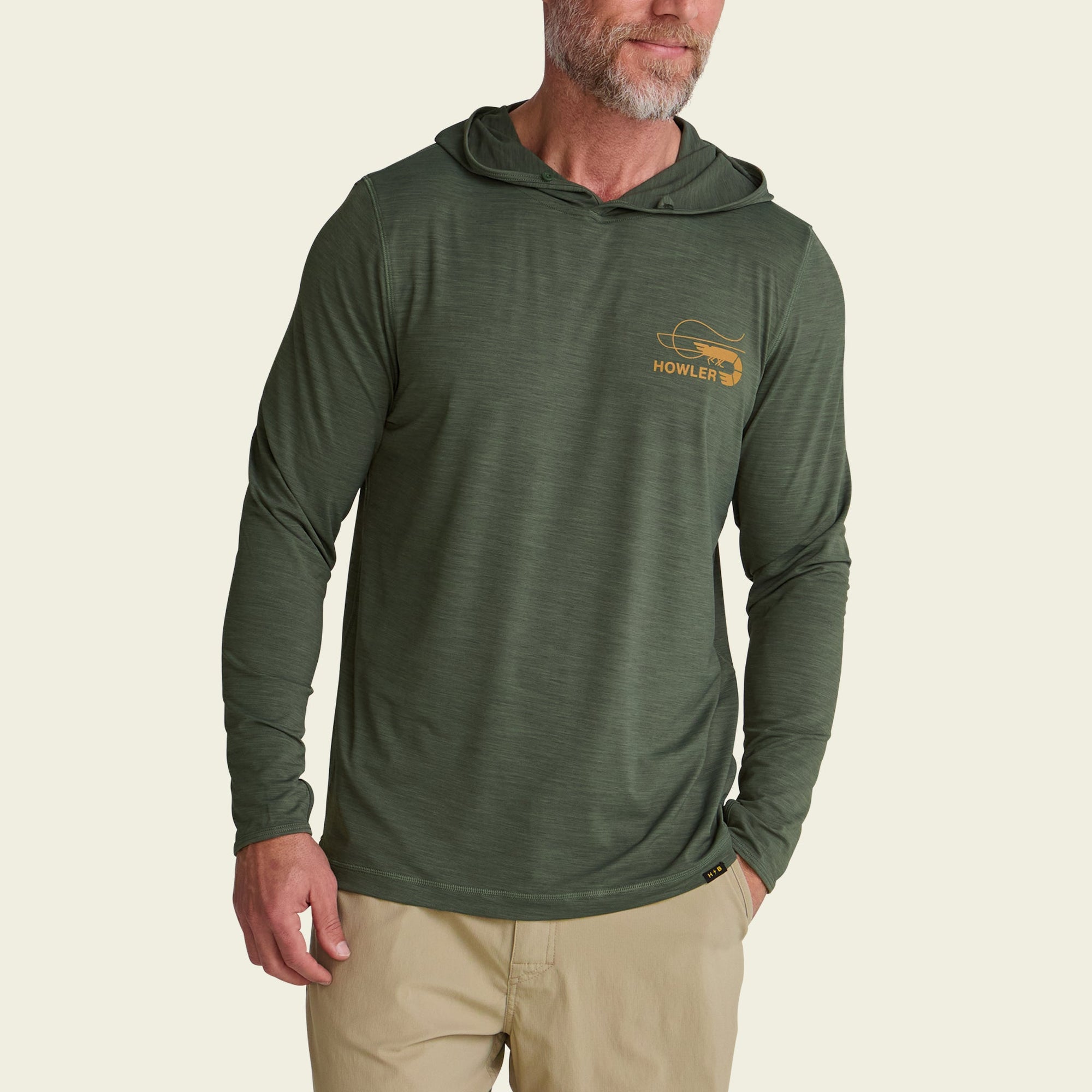 Men's olive green long-sleeve hooded shirt with front logo, modeled on beige background