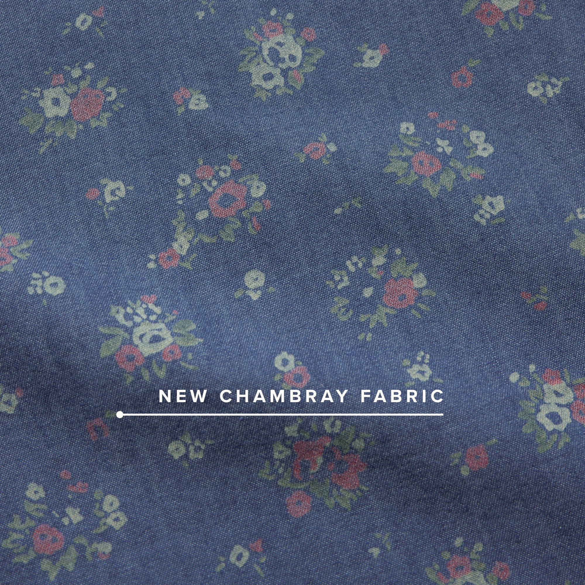 Close-up detail of blue chambray fabric with scattered small floral bouquet print pattern