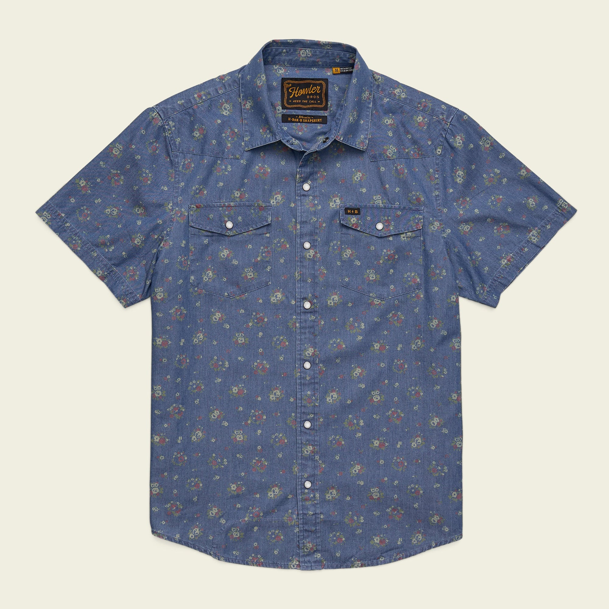 Men's short-sleeve western snap shirt in washed indigo with allover floral print, flat front view