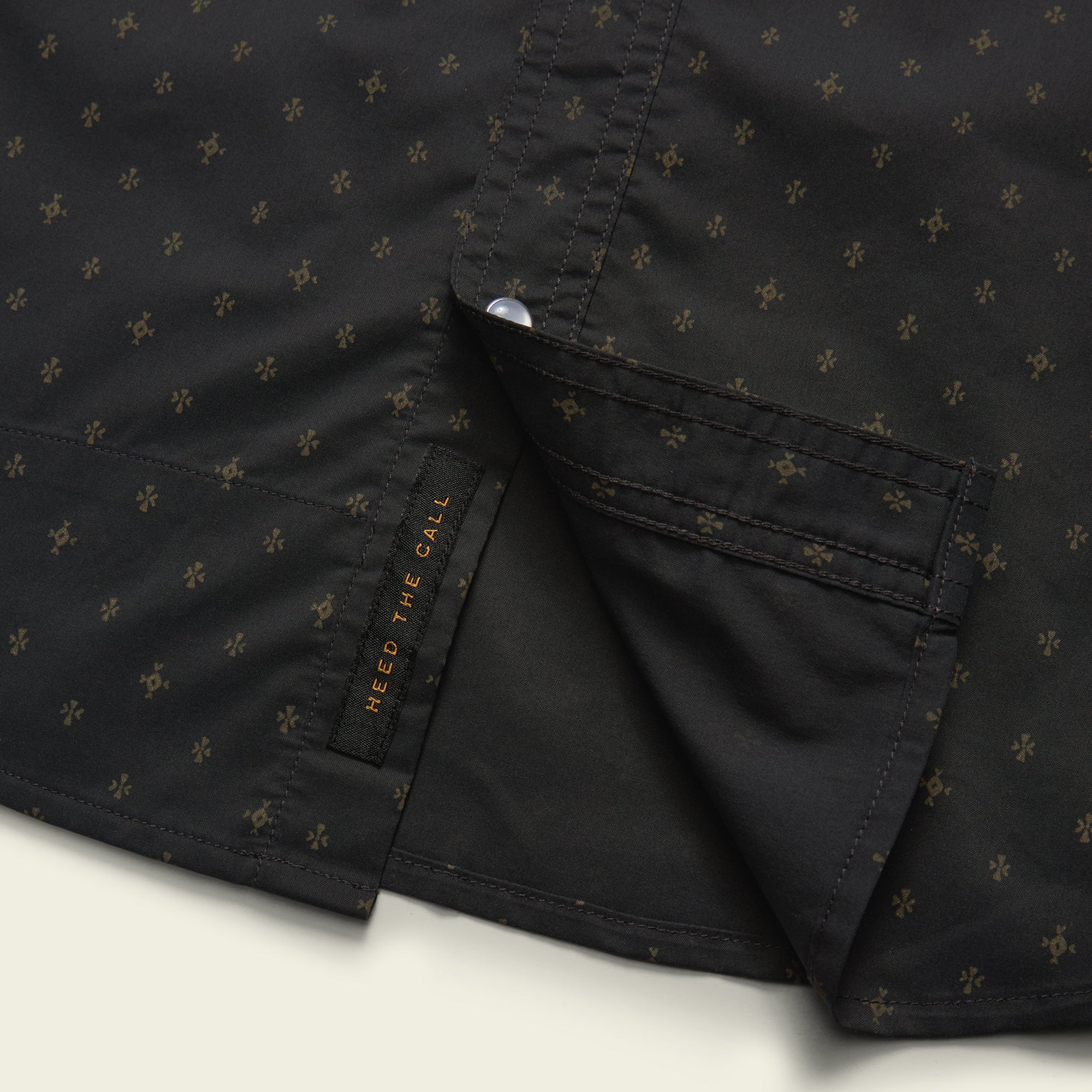 Dark button-up shirt with small star pattern, showing collar detail and chest pocket