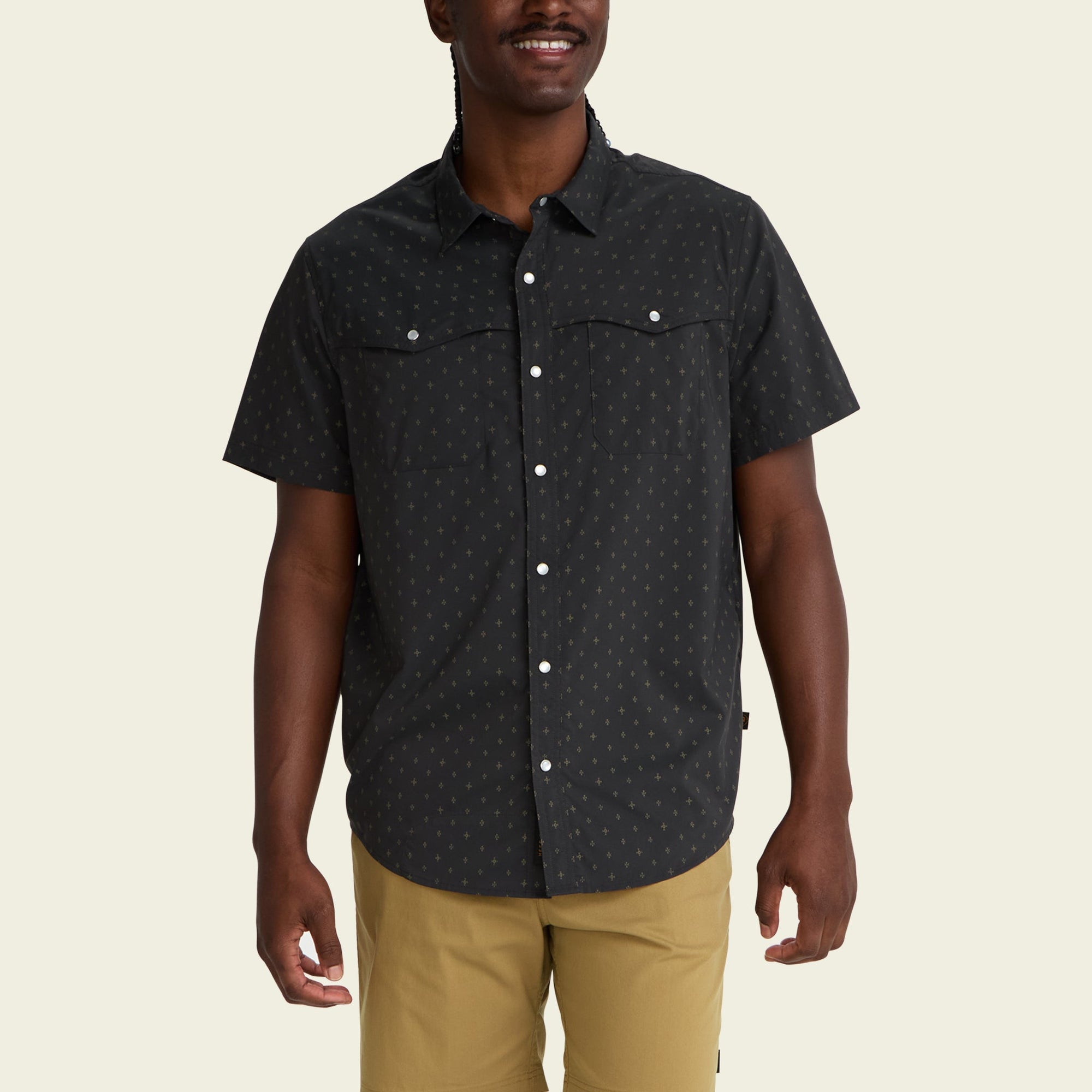 Dark patterned short-sleeve button-up shirt with chest pockets on male model
