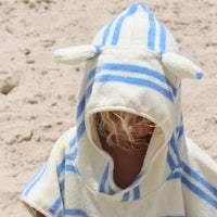 White striped hooded towel with blue accents worn by child on beach