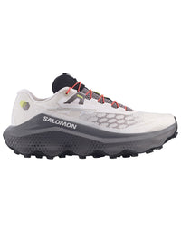 Trail running shoe with light gray mesh upper, chunky dark gray lugged outsole, and red laces, side view