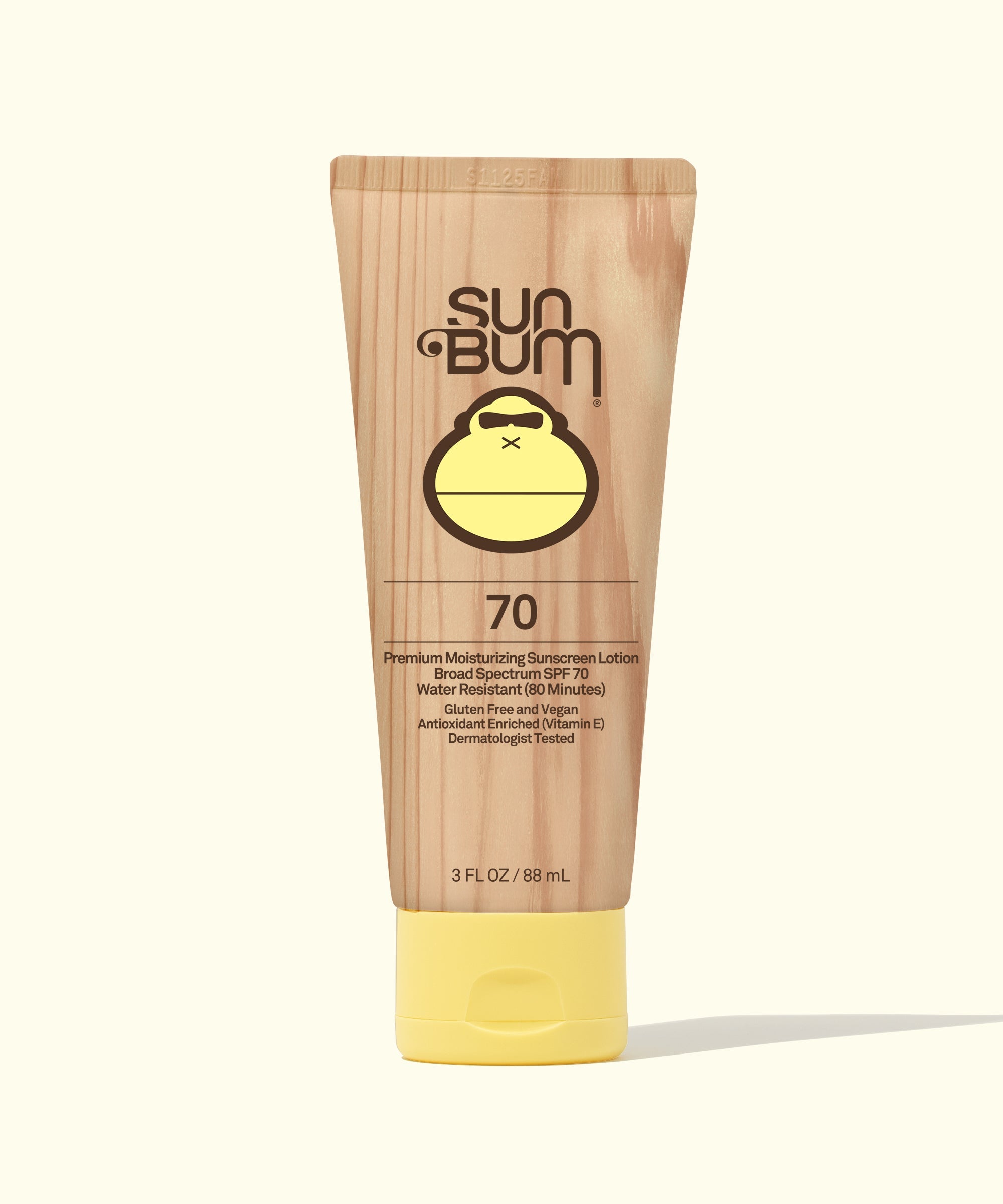 Tan sunscreen lotion tube with yellow cap showing SPF 70 rating, front view