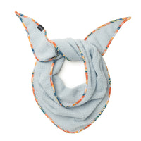 Light blue fleece scarflette with colorful floral-patterned trim, looped and tied, studio shot