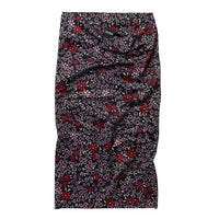 Floral patterned neck gaiter laid flat, black with red and pink flowers, tube style