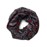 Floral print neck gaiter in black with red and pink flowers, coiled flat view